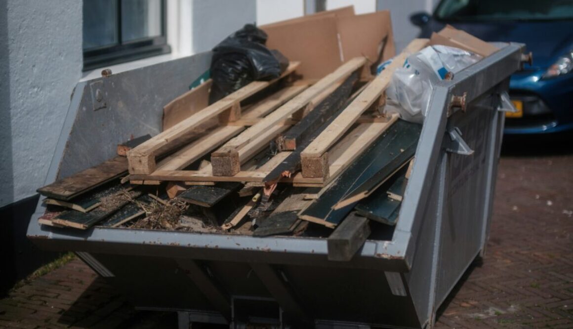 Junk Removal Broomfield Neighborhoods: Dumpster filled with wood debris for safe and eco-friendly disposal, keeping homes and yards clean and organized.