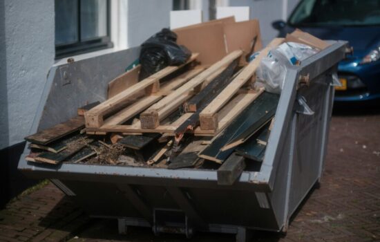 Junk Removal Broomfield Neighborhoods: Dumpster filled with wood debris for safe and eco-friendly disposal, keeping homes and yards clean and organized.