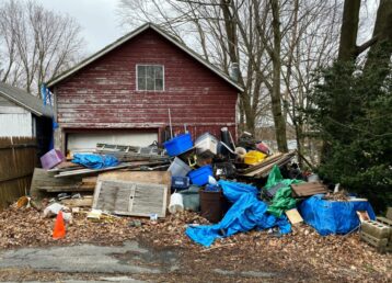 Junk removal Colorado Springs – cluttered home exterior with junk and old furniture piled in front, showing the need for professional cleanup to improve curb appeal