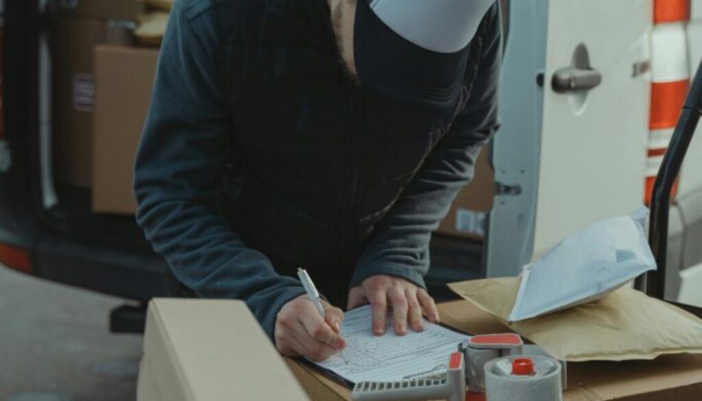 Decluttering Colorado Springs – professional worker using a checklist and organizing boxes while helping a homeowner declutter efficiently