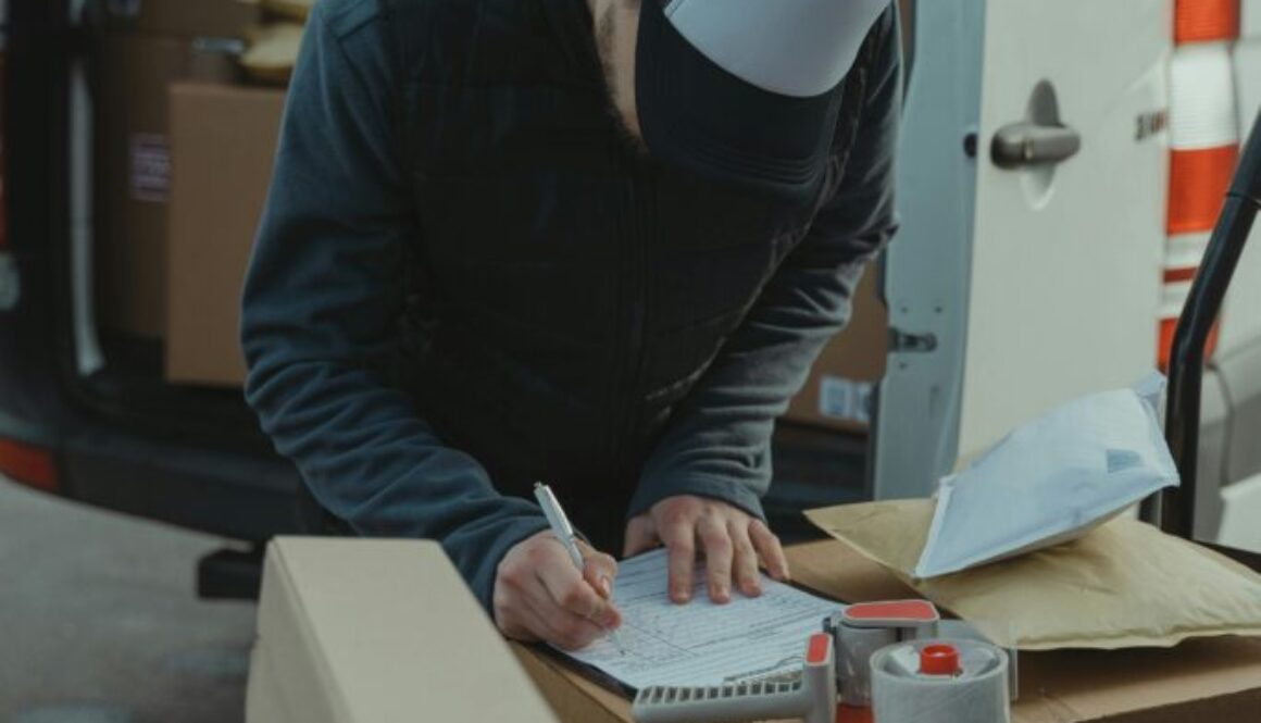 Decluttering Colorado Springs – professional worker using a checklist and organizing boxes while helping a homeowner declutter efficiently