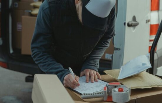 Decluttering Colorado Springs – professional worker using a checklist and organizing boxes while helping a homeowner declutter efficiently