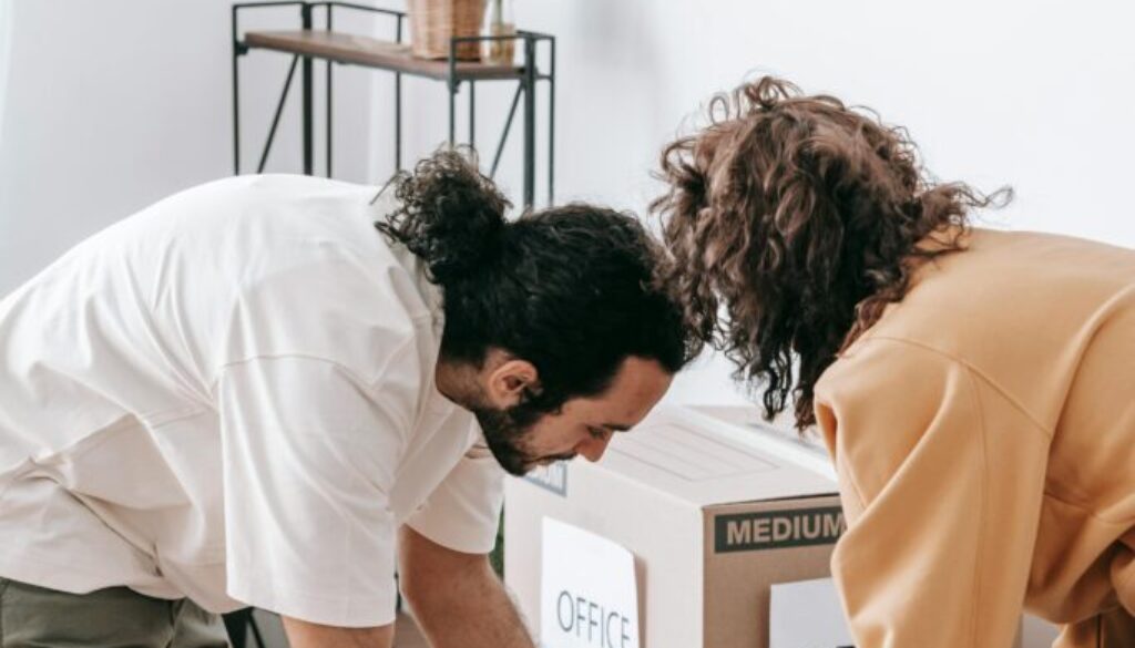 Decluttering Before Moving Broomfield: Homeowner sorting belongings and preparing items for professional junk removal to save time and reduce moving stress.